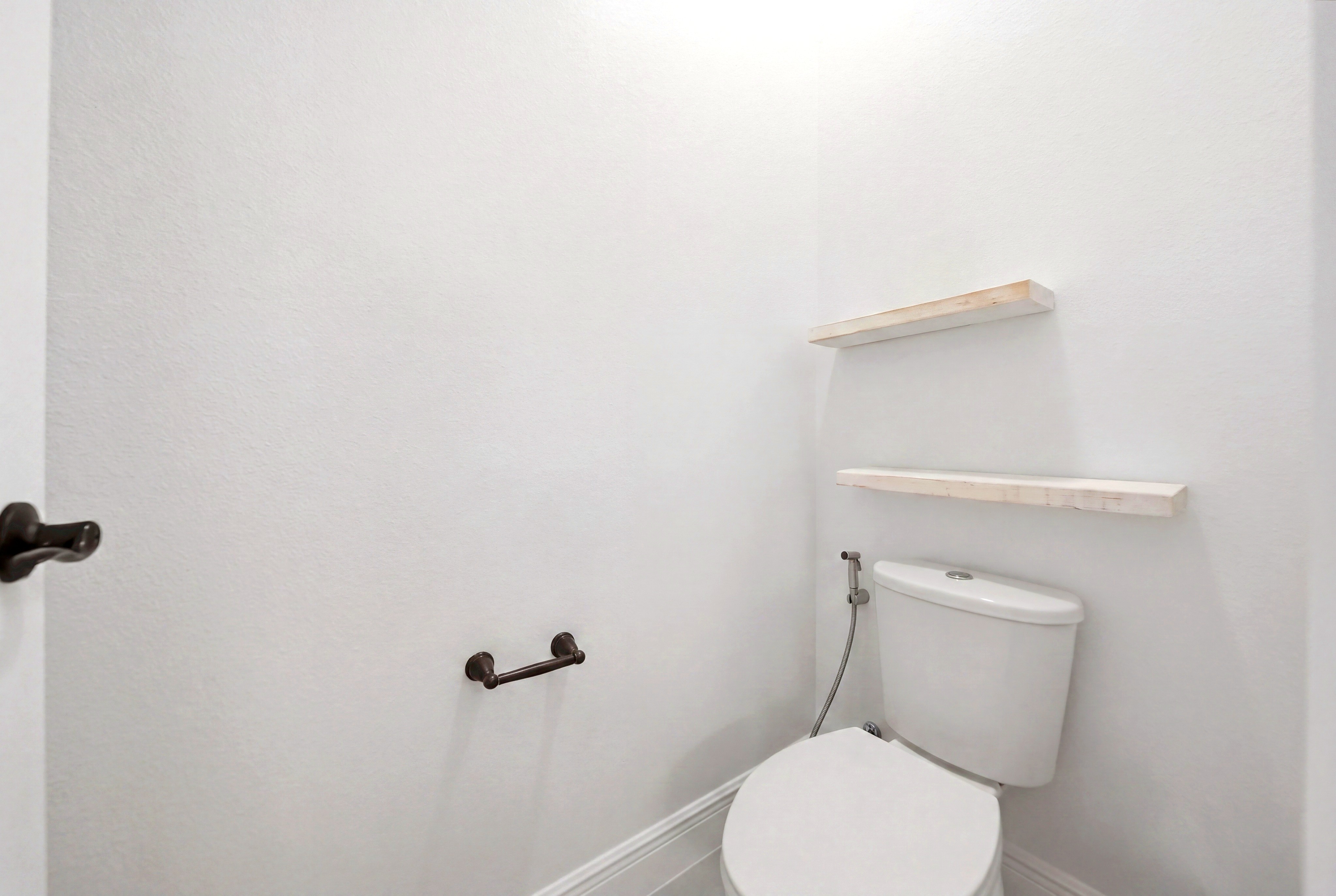 Bathroom with toilet and shelves